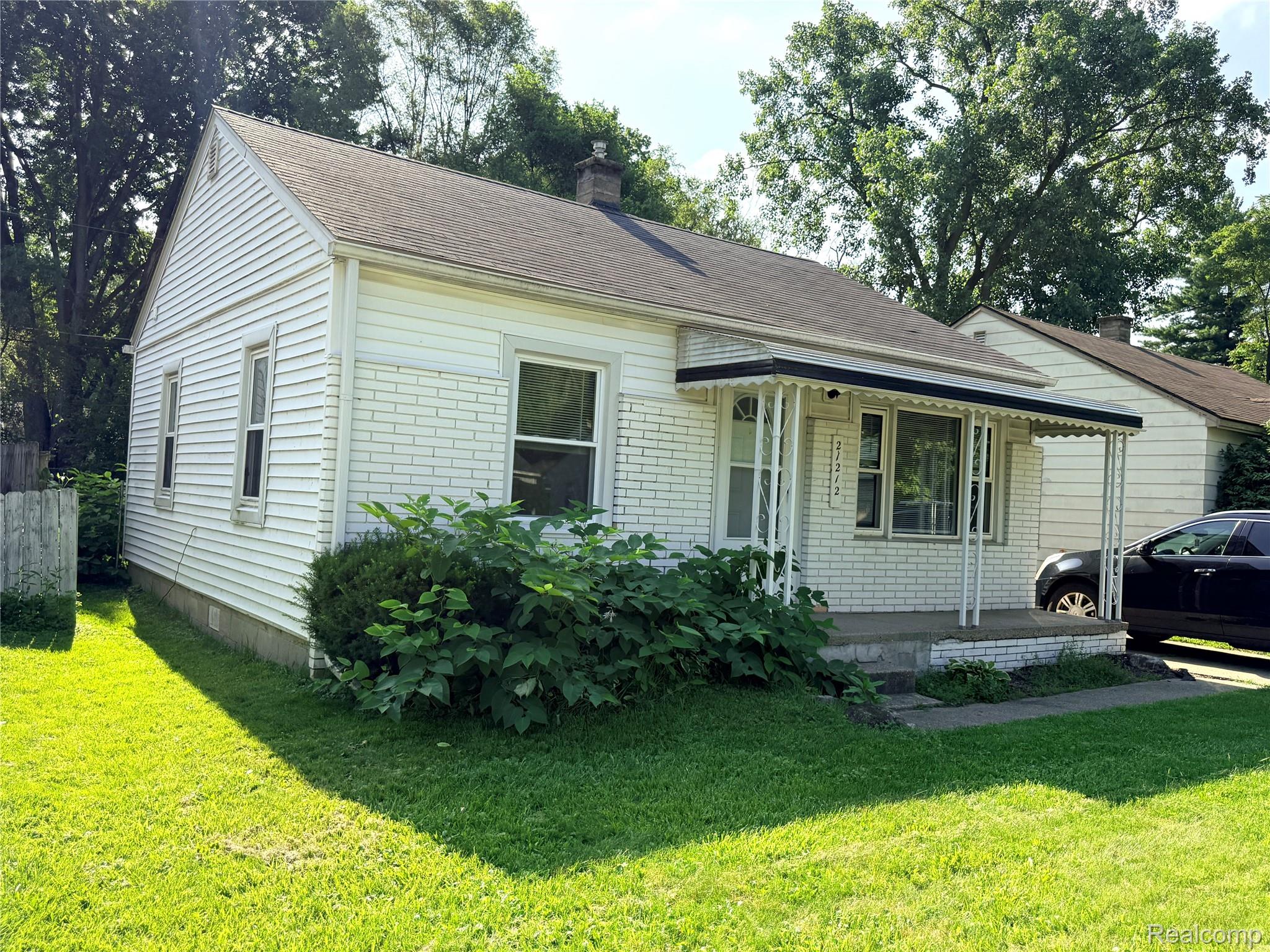 21212 Rensselaer Street Farmington, MI 48336 - Photo 1 of 11 White brick and siding exterior with a dark shingle roof