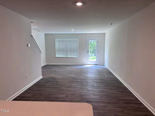 a view of room with window and hardwood floor