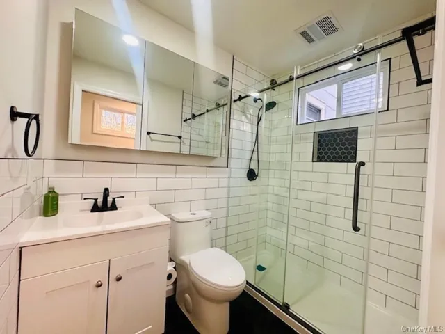 a bathroom with a sink toilet and shower