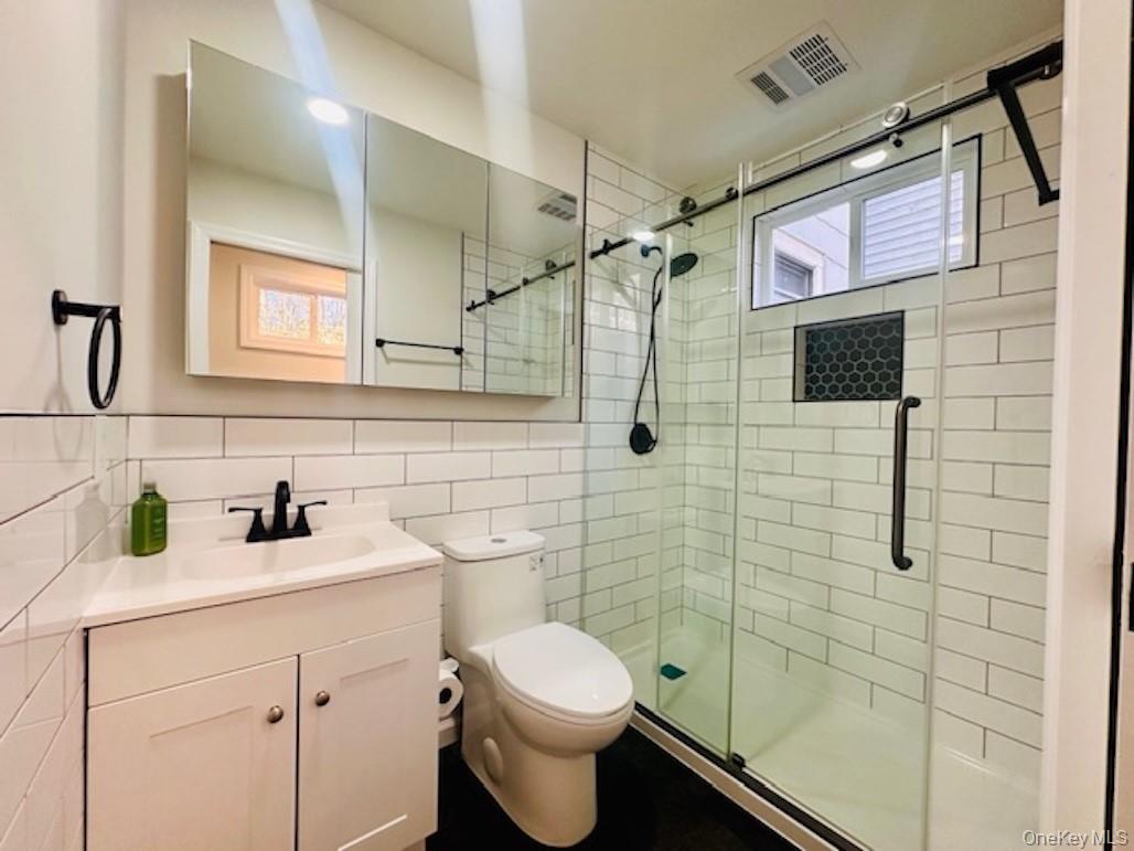 5517 Fieldston Road Bronx, NY 10471 - Photo 13 of 28 a bathroom with a sink toilet and shower
