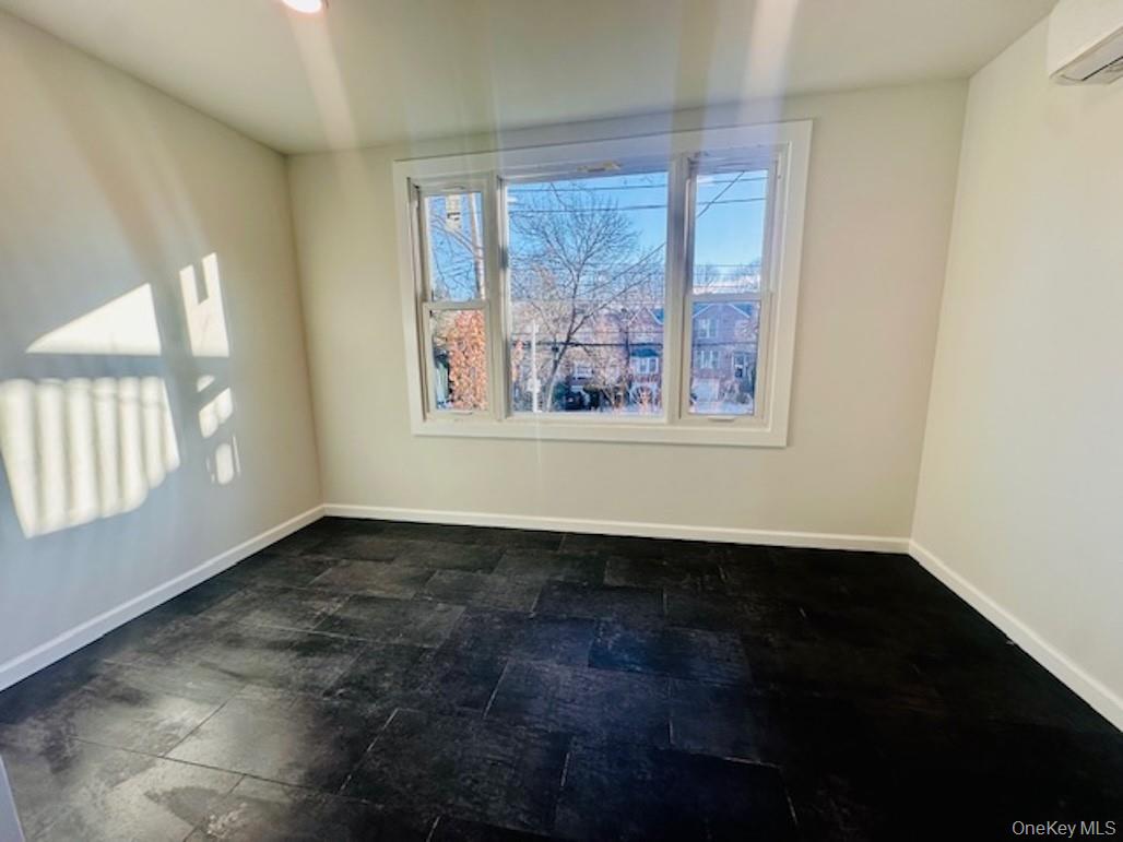 5517 Fieldston Road Bronx, NY 10471 - Photo 15 of 28 an empty room with wooden floor and windows