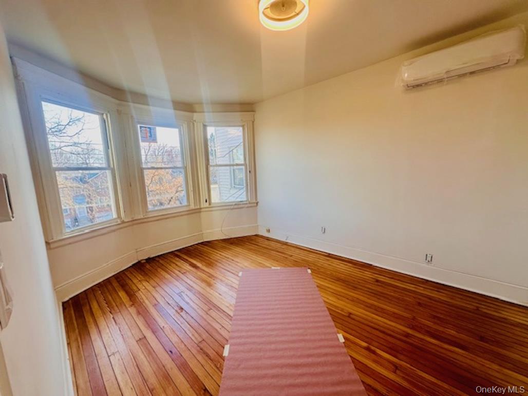 5517 Fieldston Road Bronx, NY 10471 - Photo 18 of 28 a view of empty room with wooden floor and fan