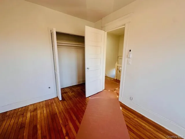 a view of a room with wooden floor and a sink