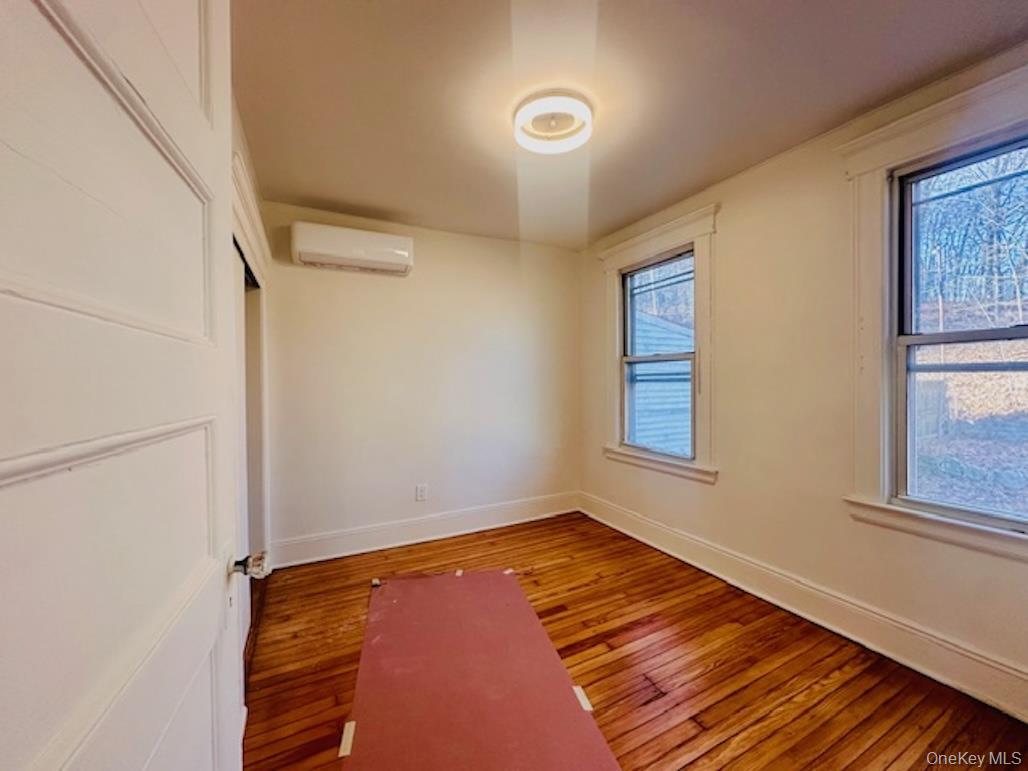 5517 Fieldston Road Bronx, NY 10471 - Photo 23 of 28 a view of an empty room with wooden floor and a window