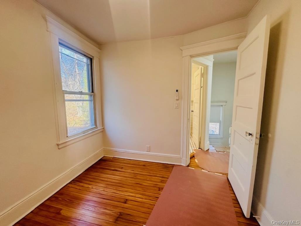 5517 Fieldston Road Bronx, NY 10471 - Photo 24 of 28 a view of an empty room with wooden floor and a window