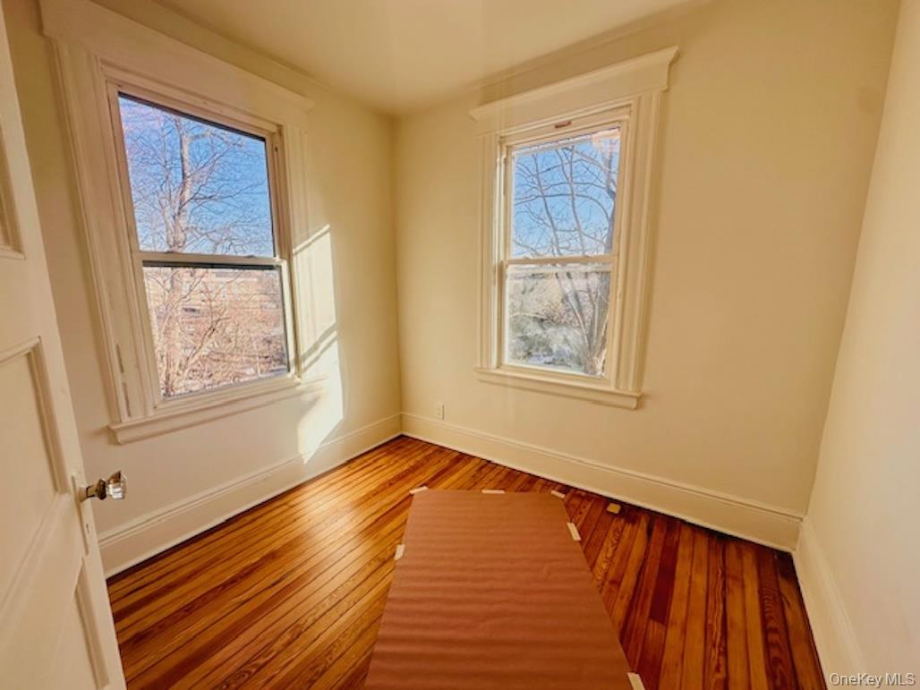 5517 Fieldston Road Bronx, NY 10471 - Photo 25 of 28 a view of an empty room with wooden floor and a window