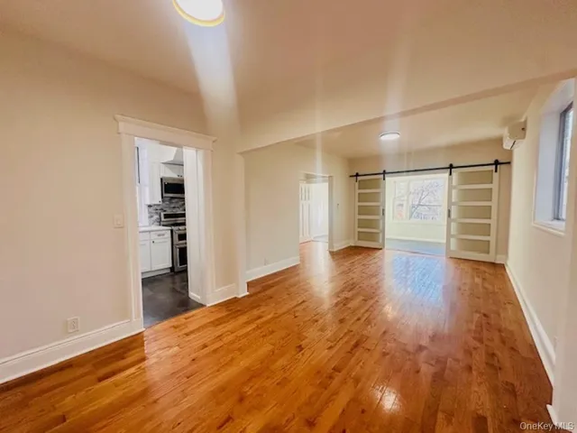 an empty room with wooden floor and closet