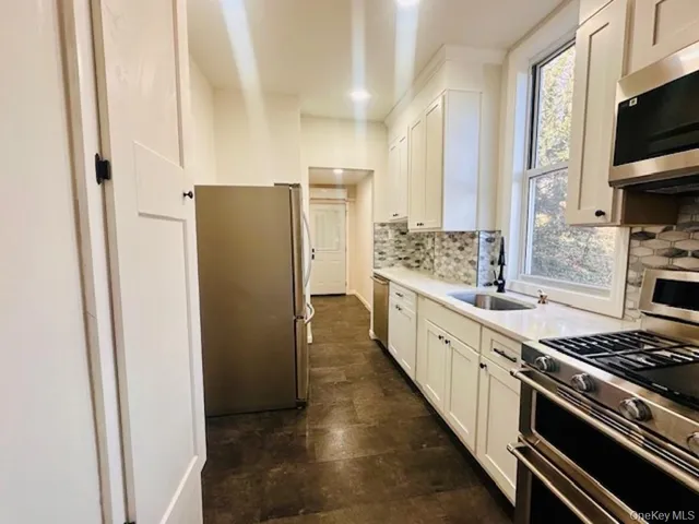 a large kitchen with a stove and a refrigerator