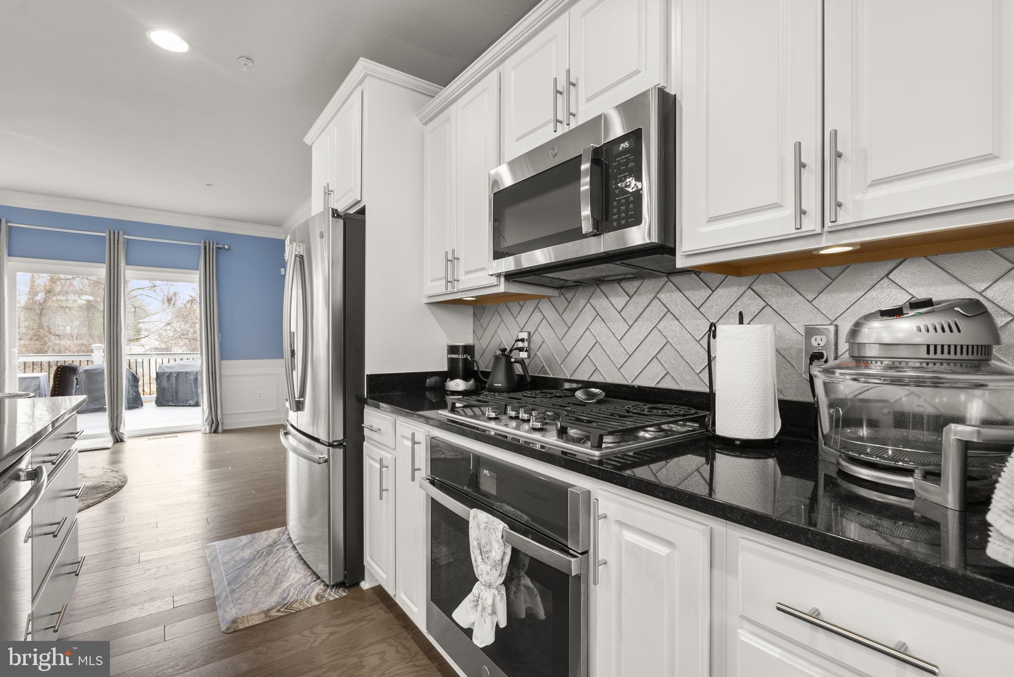 3043 Mia Lane Bowie, MD 20721 - Photo 14 of 44 a kitchen with stainless steel appliances granite countertop a stove and a microwave
