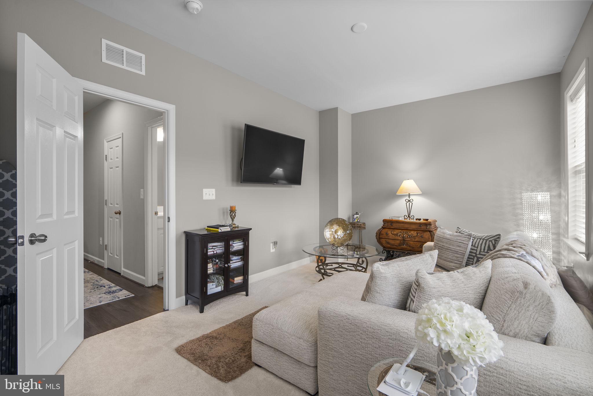 3043 Mia Lane Bowie, MD 20721 - Photo 31 of 44 a living room with furniture and a flat screen tv