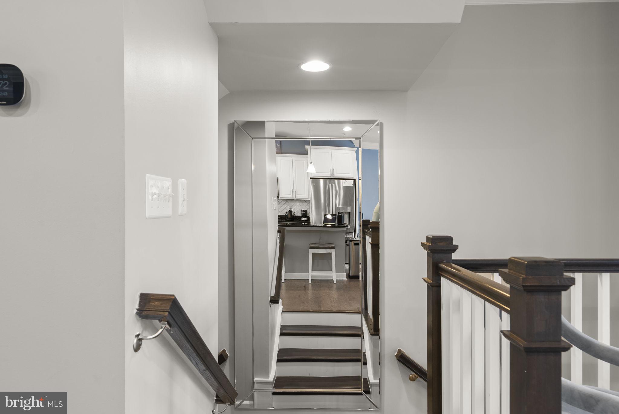 3043 Mia Lane Bowie, MD 20721 - Photo 4 of 44 a view of a hallway with wooden floor and staircase