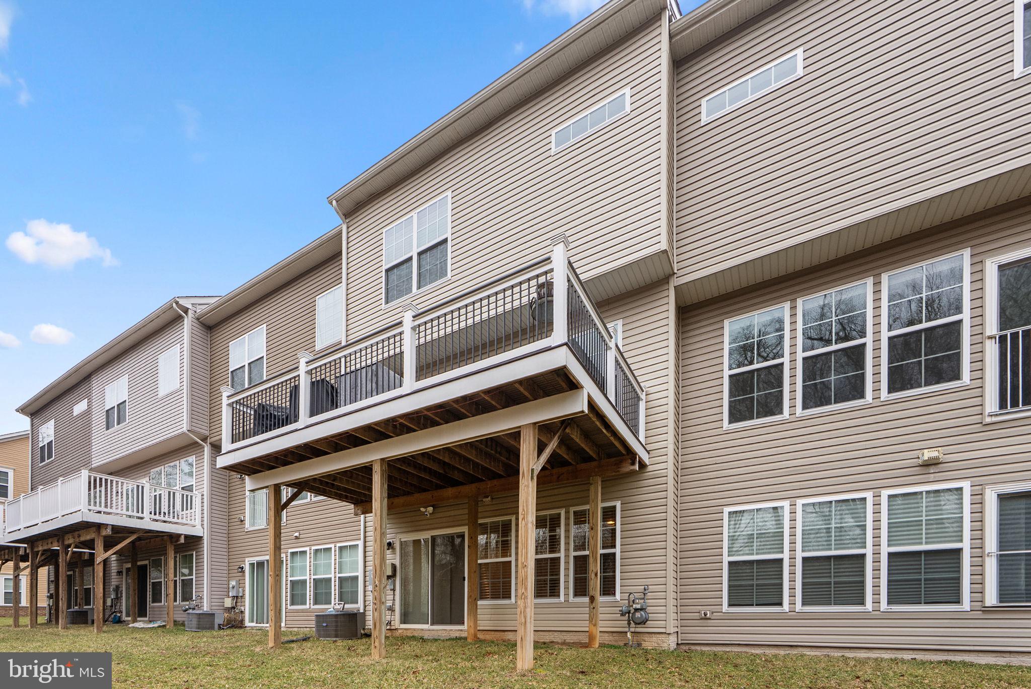 3043 Mia Lane Bowie, MD 20721 - Photo 44 of 44 a front view of a residential apartment building with a yard