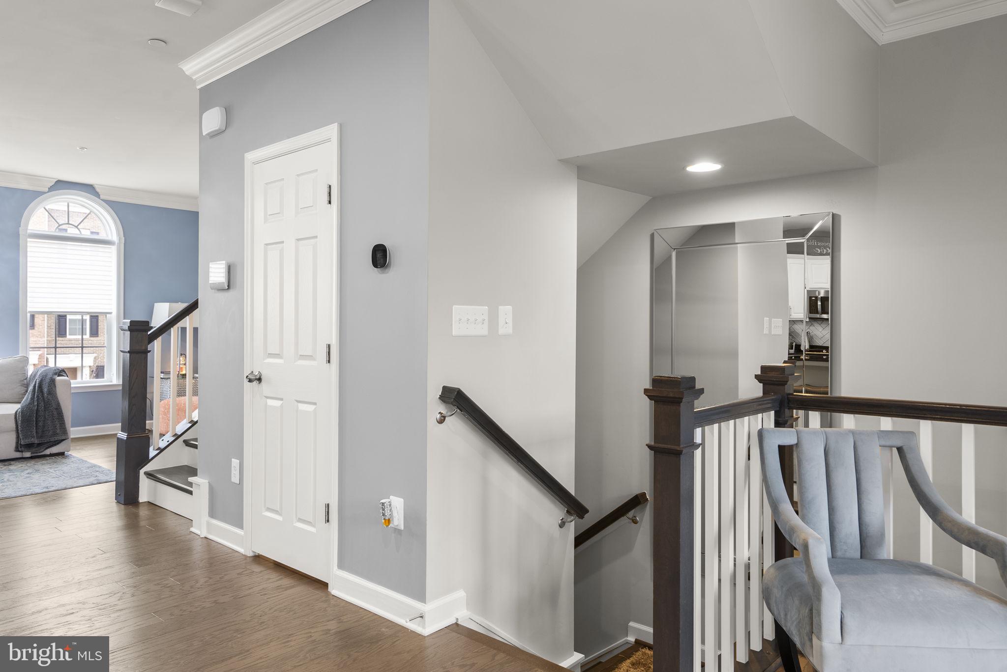 3043 Mia Lane Bowie, MD 20721 - Photo 5 of 44 a view of a hallway with wooden floor and stairs