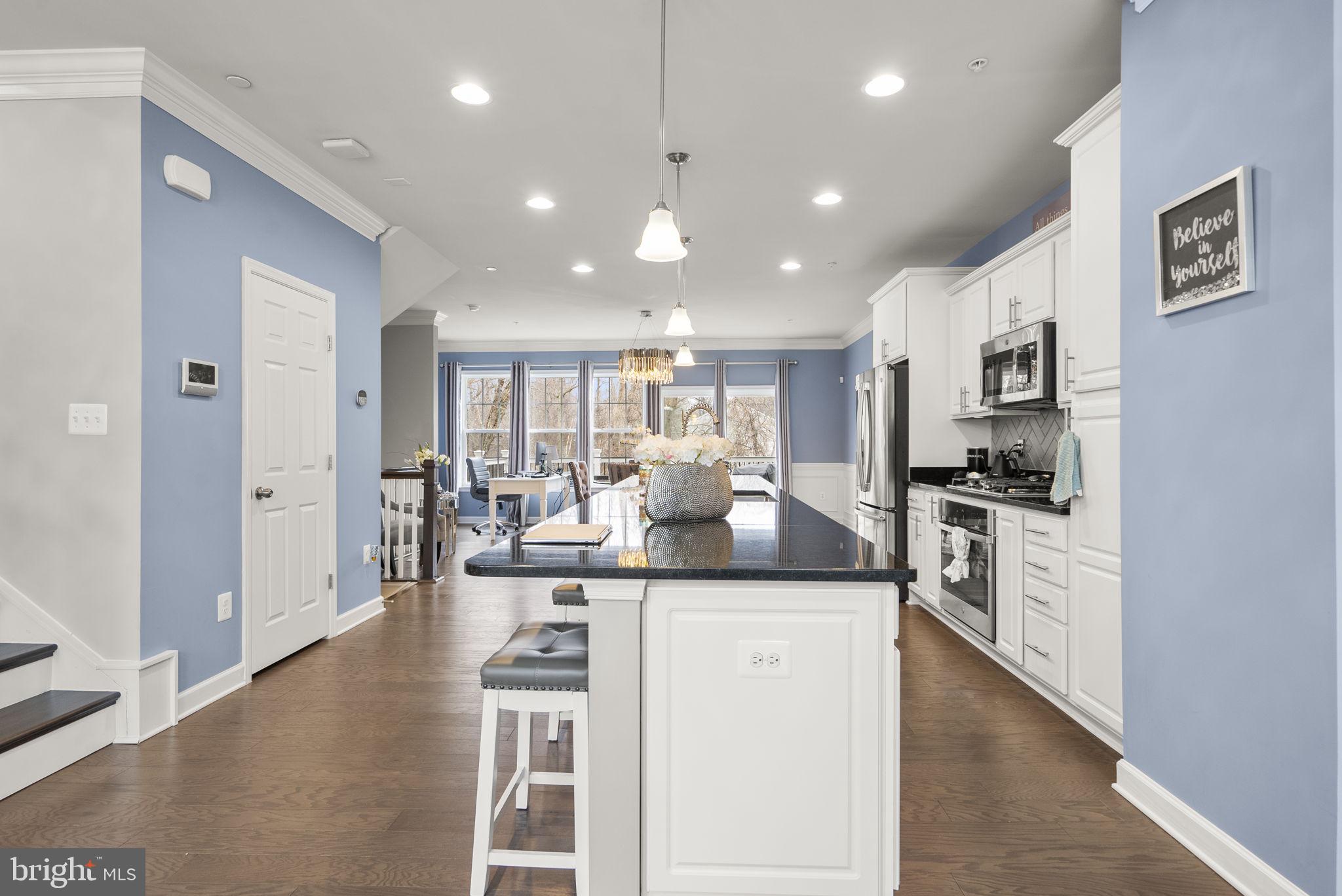 3043 Mia Lane Bowie, MD 20721 - Photo 10 of 44 a kitchen with stainless steel appliances kitchen island granite countertop a sink and cabinets