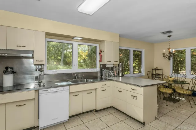 a kitchen with a sink window and cabinets