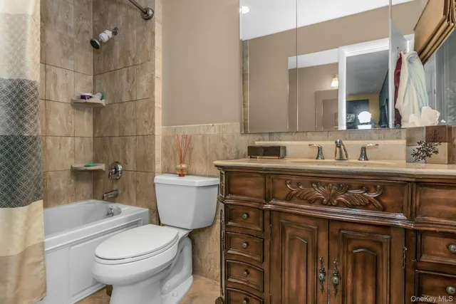a bathroom with a sink toilet vanity and shower