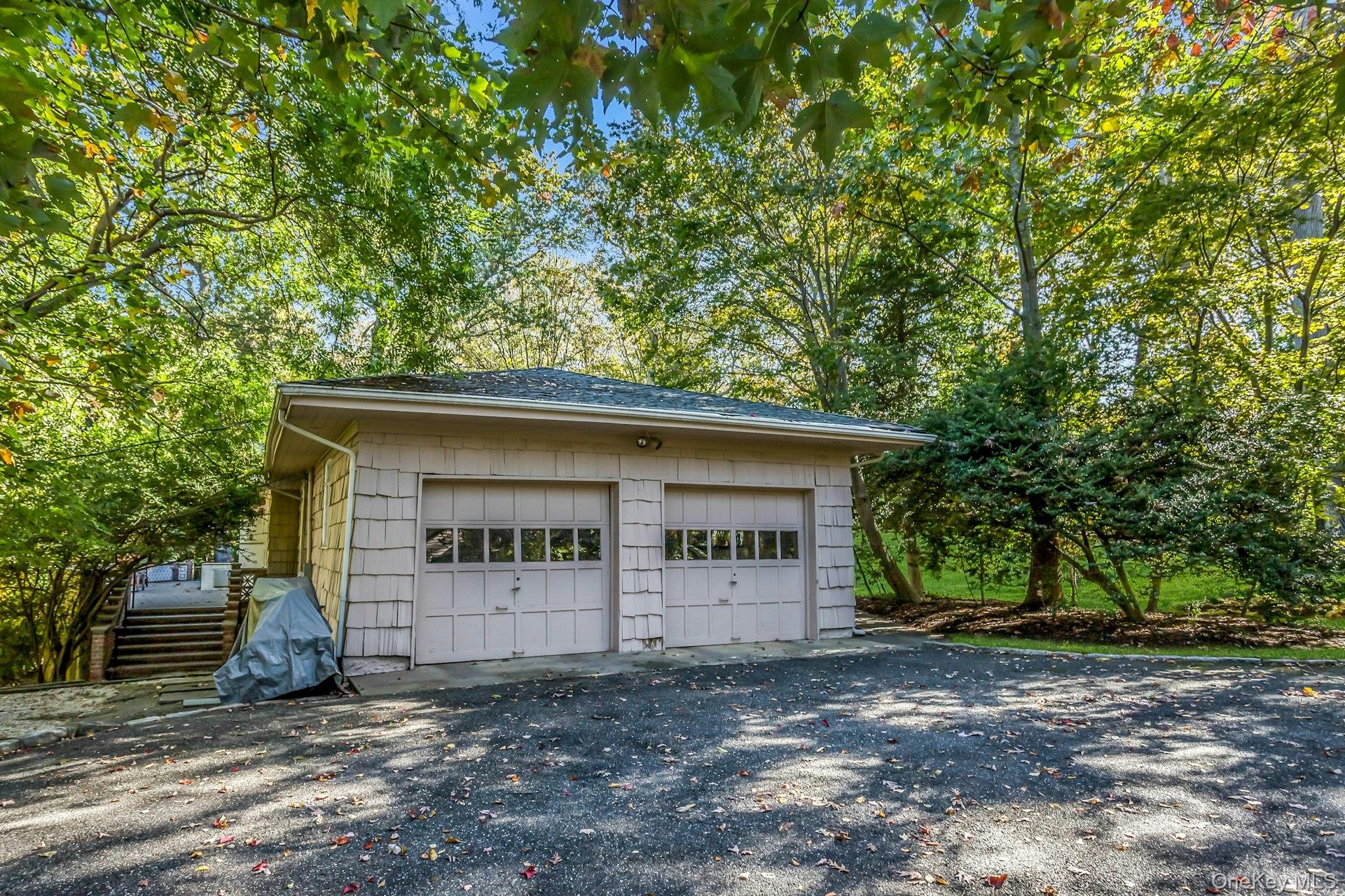 31 Knolls Lane Manhasset, NY 11030 - Photo 26 of 27 a view of a house with a garage