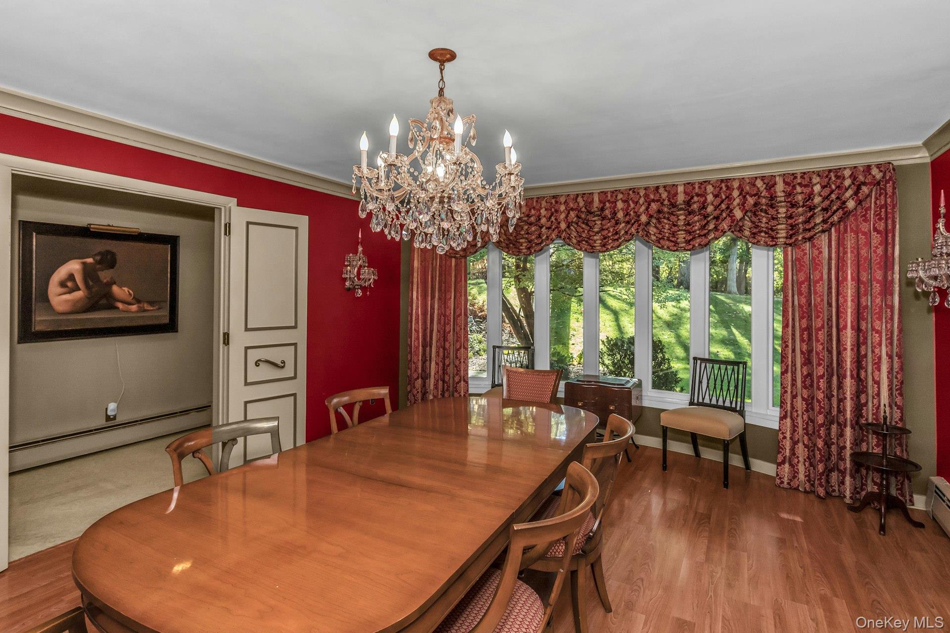31 Knolls Lane Manhasset, NY 11030 - Photo 9 of 27 a dining room with furniture a chandelier and wooden floor