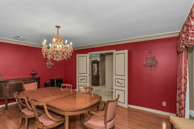 a view of a dining room with furniture and chandelier
