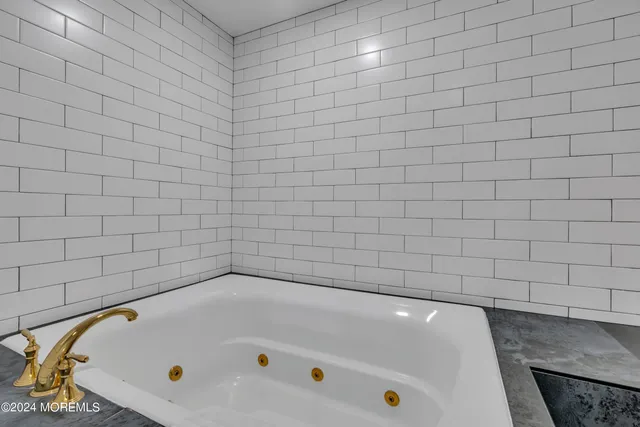 a bedroom with two beds and a chandelier