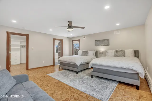 a bedroom with two beds and painting on the wall