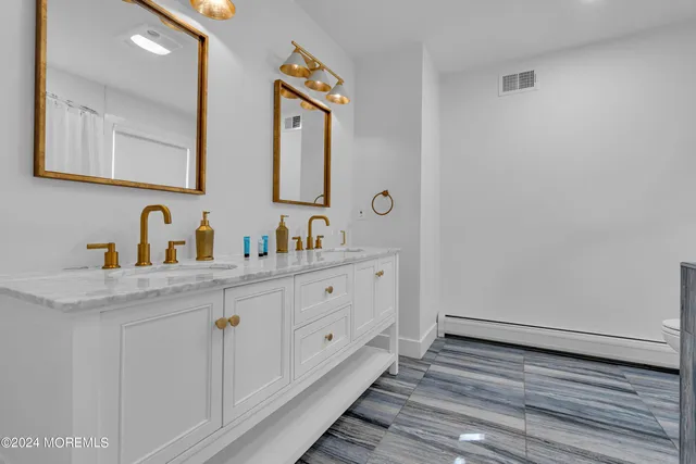 a bedroom with two beds and painting on the wall