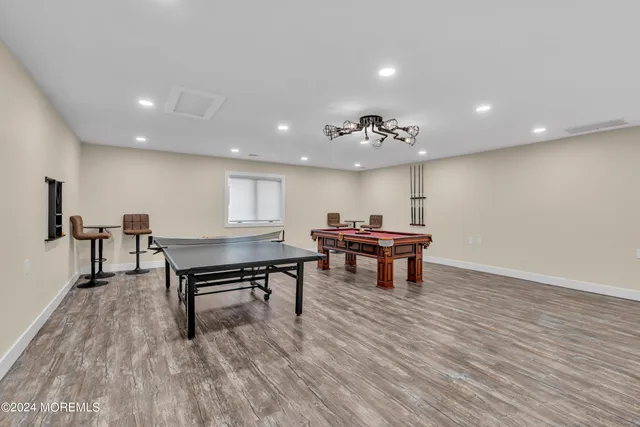 a spacious bedroom with two beds and painting on the wall