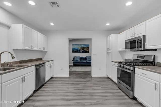 a view of a forest with trees in the background