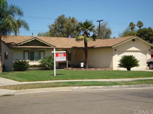 8667 Raintree Avenue Riverside, CA 92504 - Photo 1 of 1 a front view of a house with a garden and trees