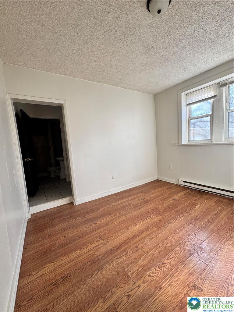 1218 Mechanic Street, Unit 2 Bethlehem, PA 18015 - Photo 3 of 9 a view of an empty room with wooden floor and a window