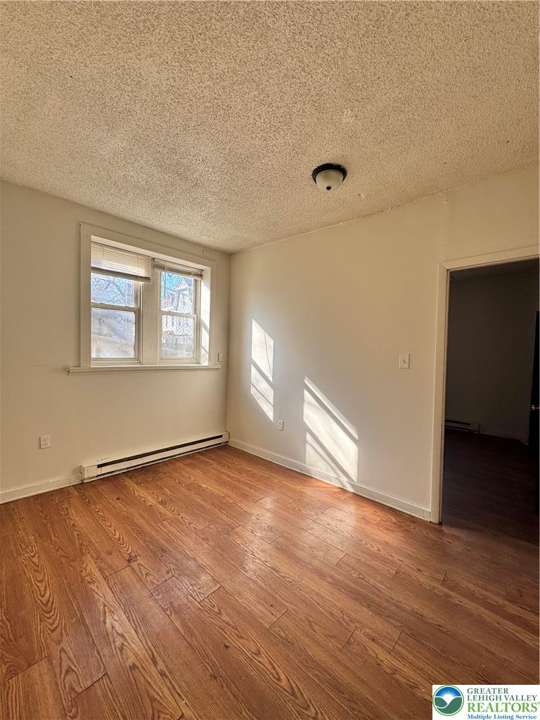 1218 Mechanic Street, Unit 2 Bethlehem, PA 18015 - Photo 5 of 9 a view of an empty room with wooden floor and a window