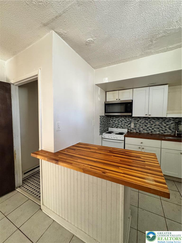 1218 Mechanic Street, Unit 2 Bethlehem, PA 18015 - Photo 7 of 9 a bedroom with a bed and a stove top oven