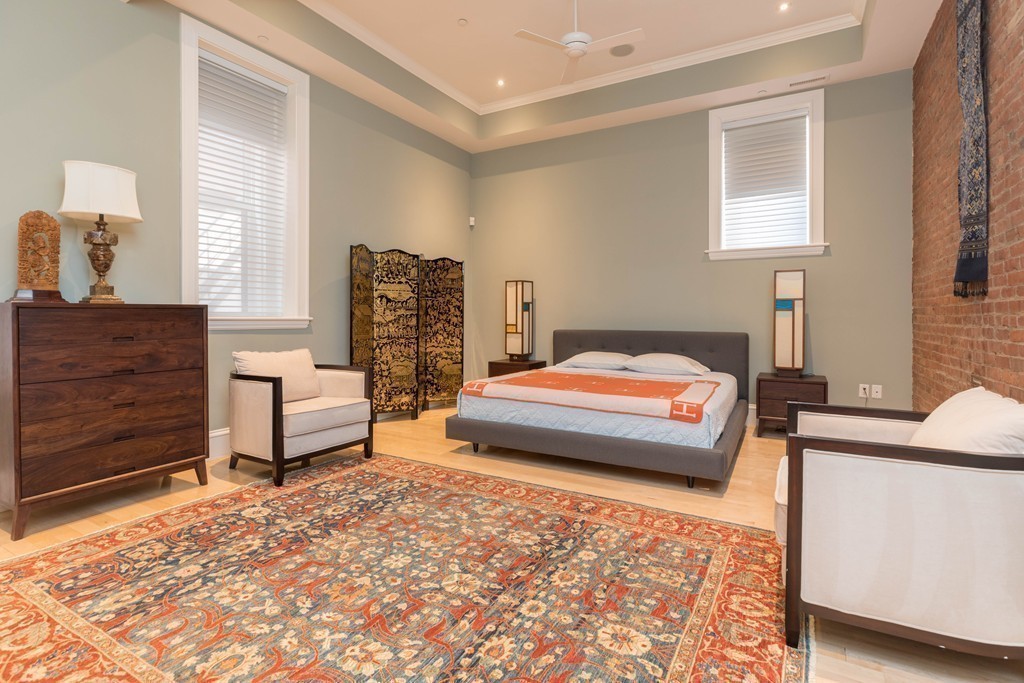 112 Beach Street, Unit 1 Boston, MA 02111 - Photo 11 of 20 a bedroom with a bed and wooden floor