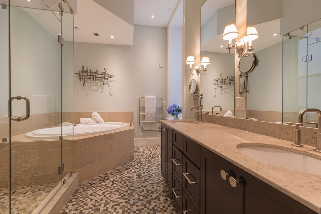 112 Beach Street, Unit 1 Boston, MA 02111 - Photo 12 of 20 a spacious bathroom with a granite countertop sink a mirror and a bathtub