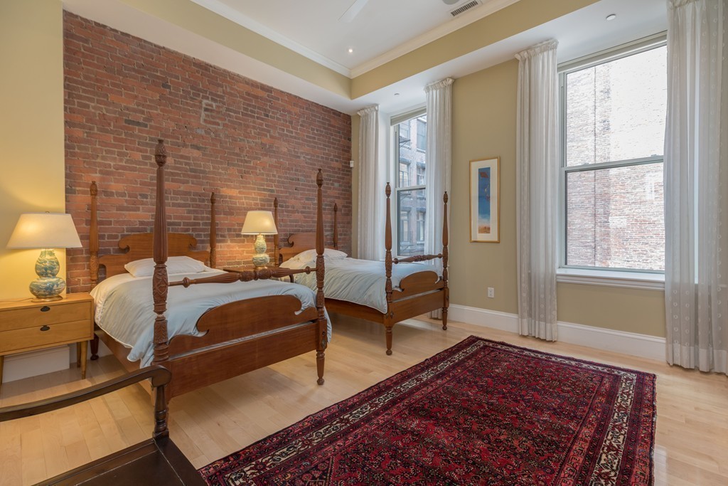112 Beach Street, Unit 1 Boston, MA 02111 - Photo 15 of 20 a bedroom with furniture and a window
