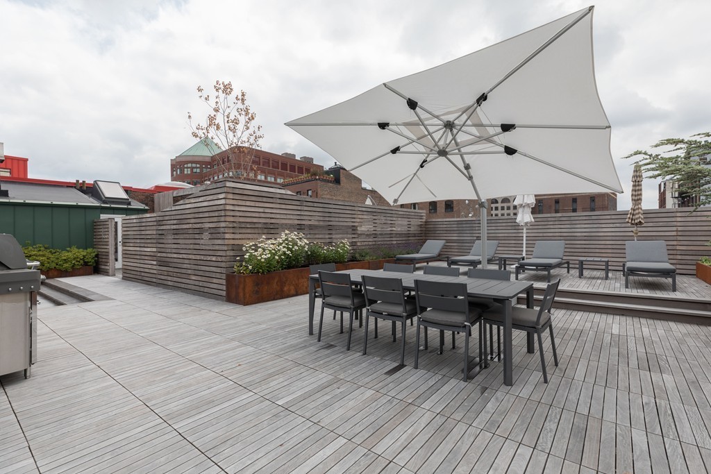 112 Beach Street, Unit 1 Boston, MA 02111 - Photo 18 of 20 a view of a patio with a table and chairs