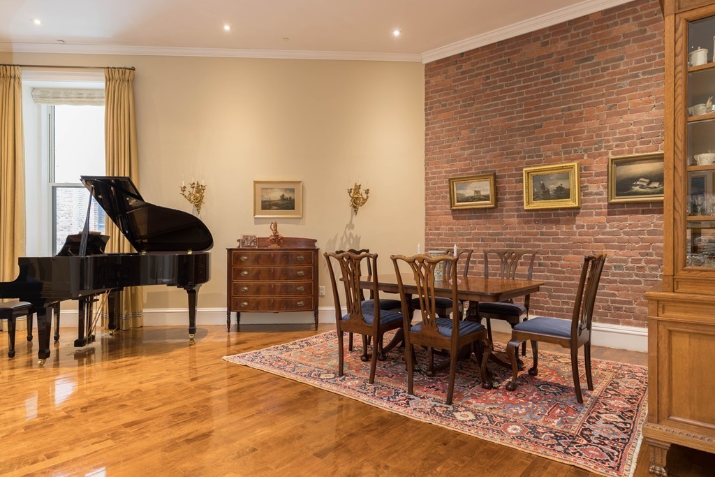 112 Beach Street, Unit 1 Boston, MA 02111 - Photo 4 of 20 a dining room with furniture wooden floor and a rug