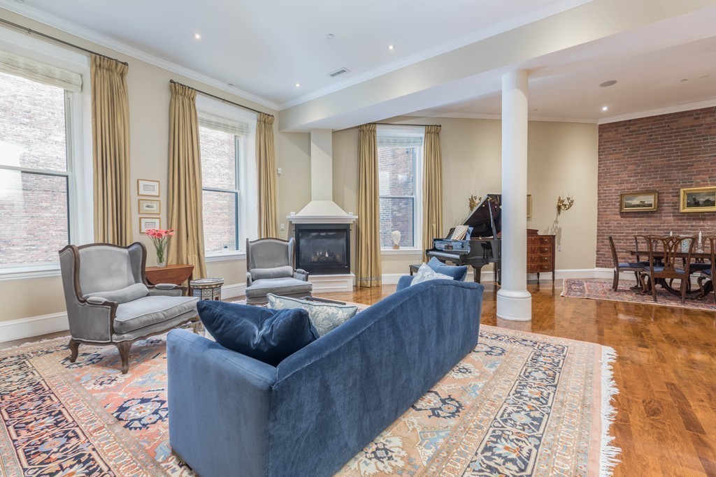 112 Beach Street, Unit 1 Boston, MA 02111 - Photo 5 of 20 a living room with furniture and a fireplace
