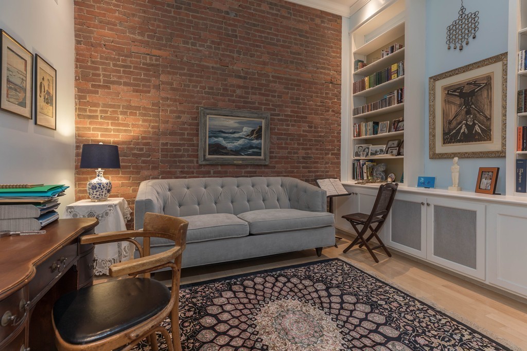 112 Beach Street, Unit 1 Boston, MA 02111 - Photo 7 of 20 a living room with furniture and a window