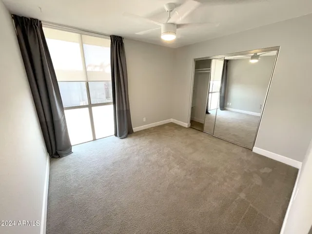 an empty room with windows and entrance