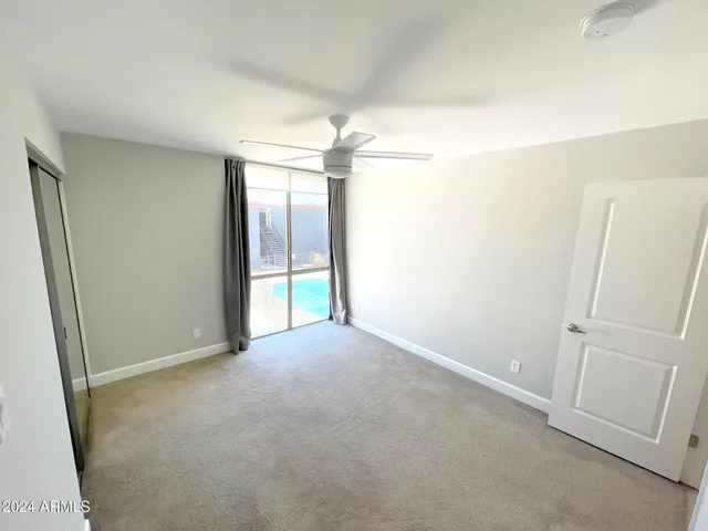 an empty room with windows and closet