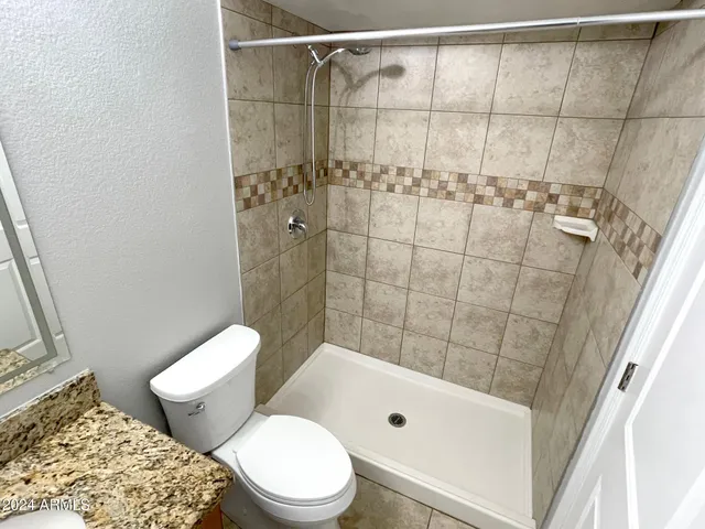 a bathroom with a toilet and shower