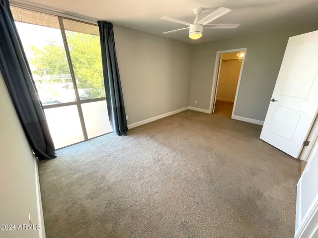 an empty room with windows and entrance