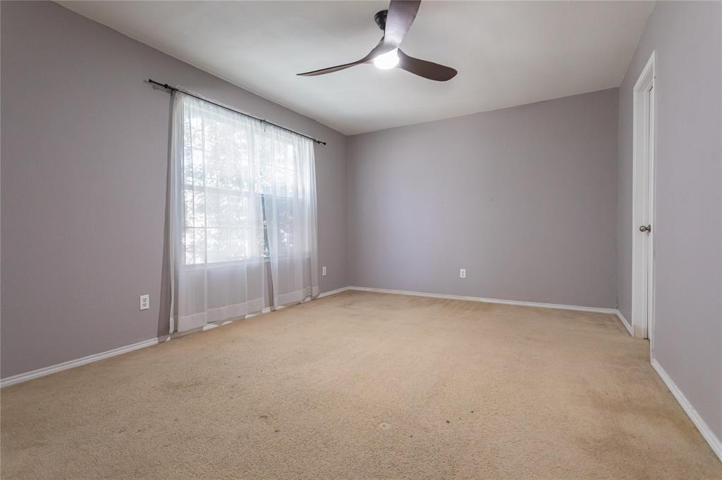149 Independence Avenue Venus, TX 76084 - Photo 11 of 31 an empty room with chandelier fan and windows