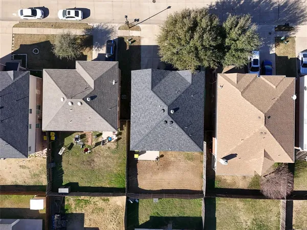 an aerial view of houses with yard