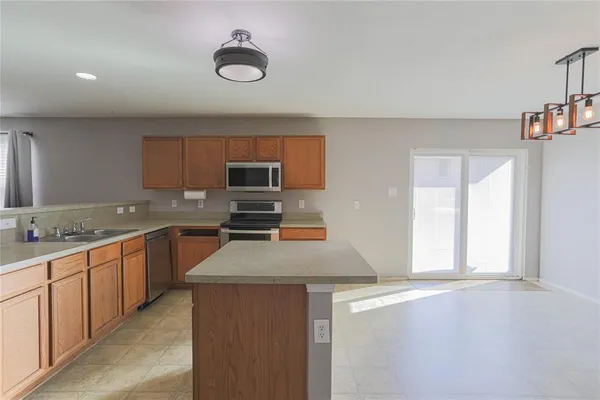 a kitchen with stainless steel appliances granite countertop a sink and dishwasher a stove with wooden floor