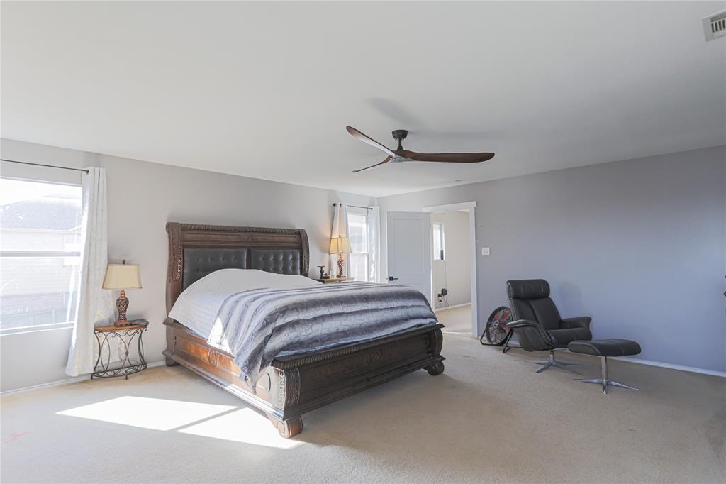 149 Independence Avenue Venus, TX 76084 - Photo 4 of 31 a spacious bedroom with a bed and chair