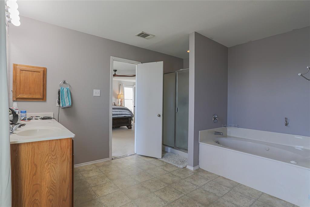 149 Independence Avenue Venus, TX 76084 - Photo 5 of 31 a bathroom with a tub sink and mirror