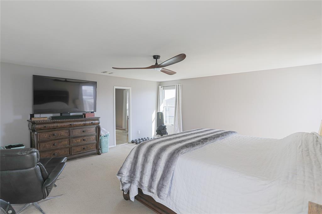 149 Independence Avenue Venus, TX 76084 - Photo 7 of 31 a bedroom with a bed and a flat screen tv