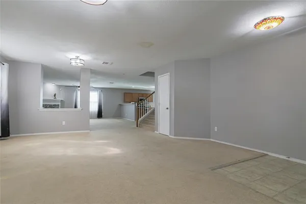 a view of empty room with a fireplace
